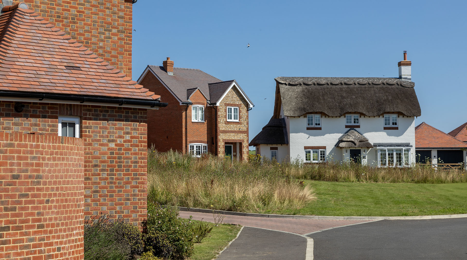 the use of different roof tile colours by Clean Slate Ltd at St Marys Hill adds to the village feeling of this new development